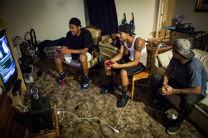 From left, Lerontae Trahan, Llijah Turner, Terrick Bakhit and Matt Bakhit relax and play video games in Spring Valley, California, September 24, 2014. All former foster youth, they spend a lot of time together and serve as a mutual support system. Terrick Bakhit is a former foster child who's struggled to make his way as an adult. He spent his 18th birthday incarcerated after a three-minute joyride in his group home van, so is unable to take advantage of AB12 – California legislation that gives assistance to foster youth as they transition into adulthood.